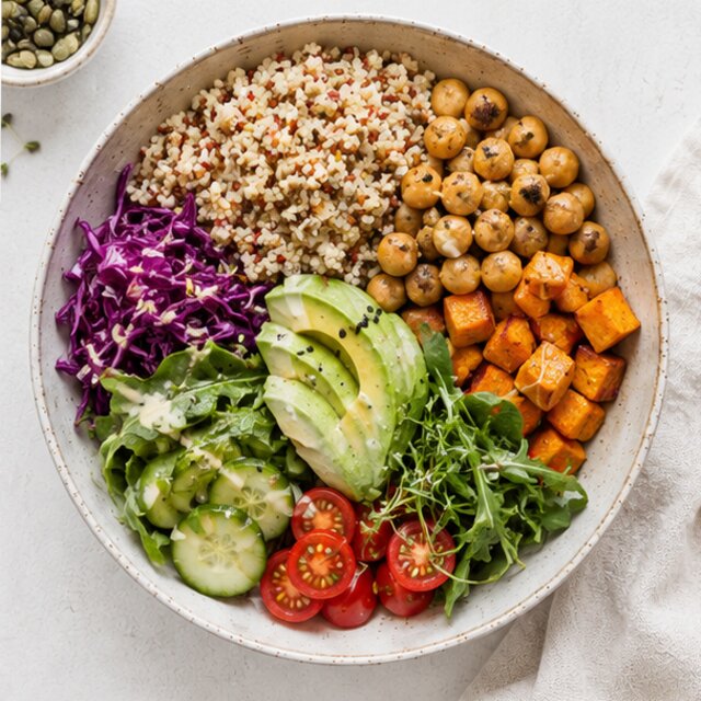 Bowl with bulgur, chickpeas, cucumbers and tahini dressing